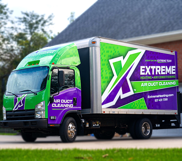 The Extreme air duct cleaning truck parked outside a home