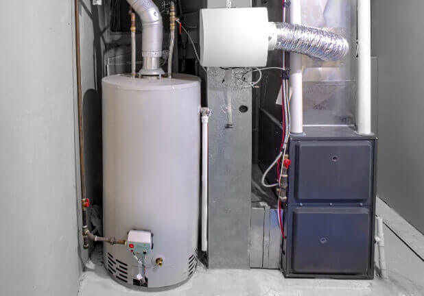 A whole-home humidifier and furnace in a basement utility area